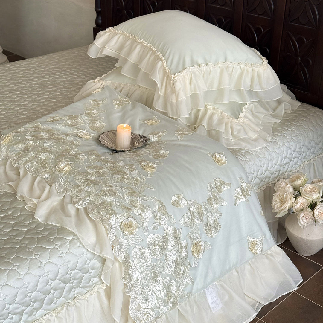 Romantic bedding set with quilted bedspread, ruffled pillow and floral embroidery