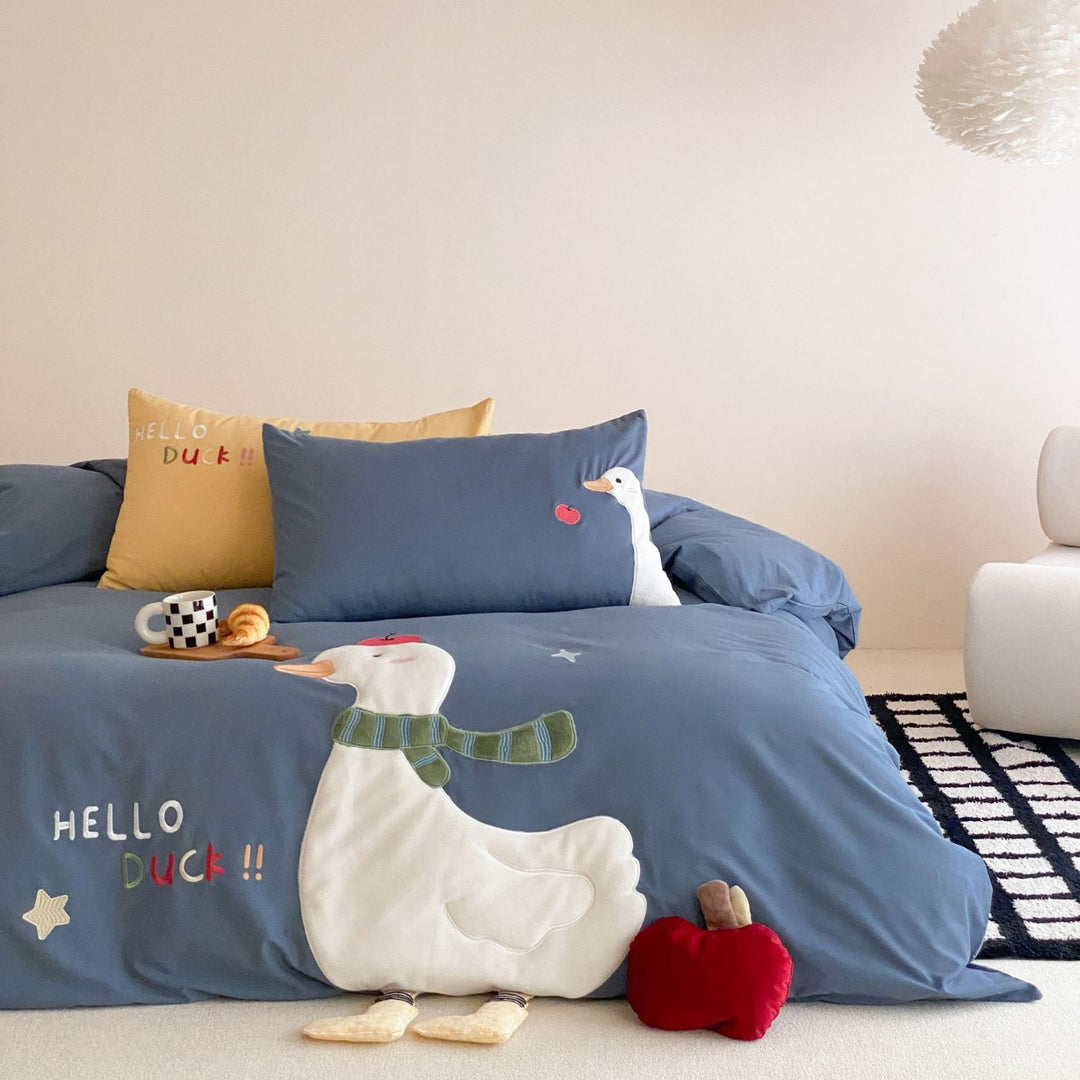 Children's bedding set with appliquéd duck figure, embroidered details, and extra soft microfiber cover