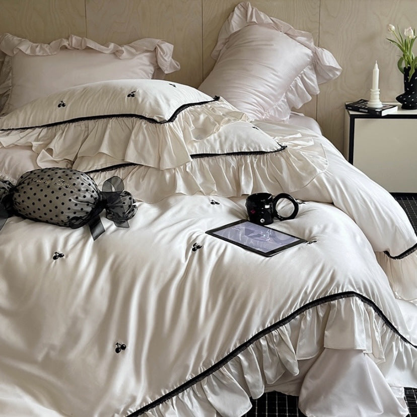 Silk-gloss satin bedding set with ruffled trim and delicate cherry embroidery
