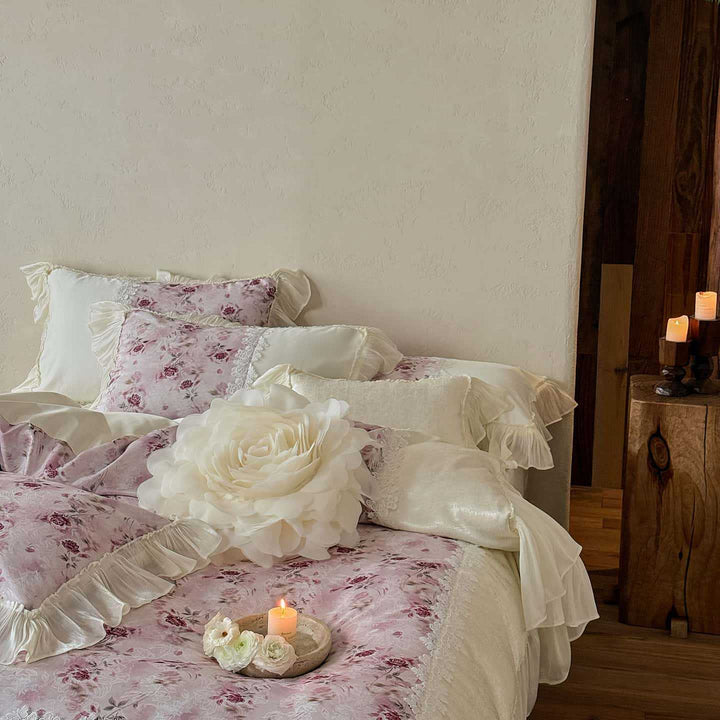 Romantic bedding and bedspread set with ruffles, lace trim, and floral quilting