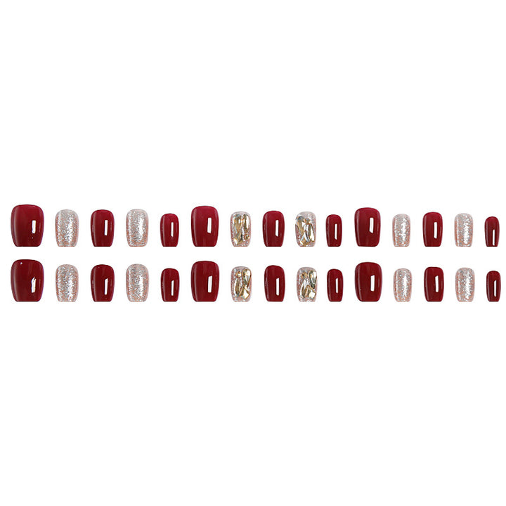 Artificial nail set with elegant glitter and metallic accents Stornfield