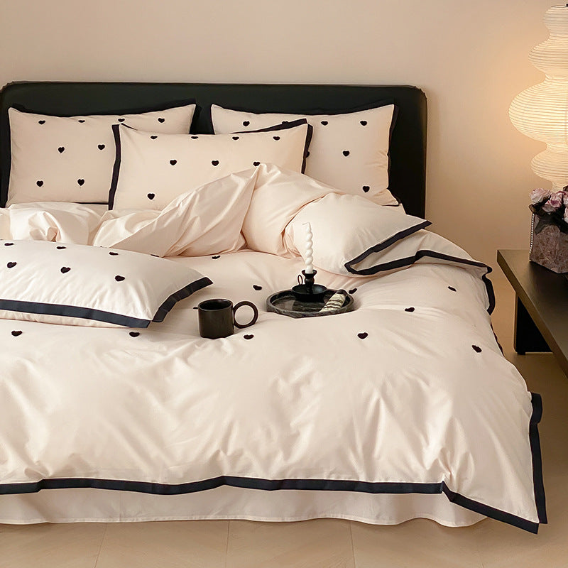 High-quality cotton satin bedding set with delicate embroidery, reversible feature & piping edge