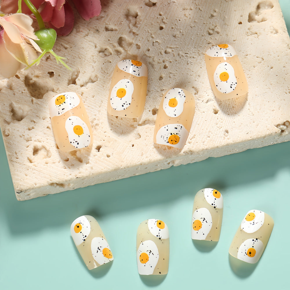 Artificial nails in creative fried egg design Stornfield