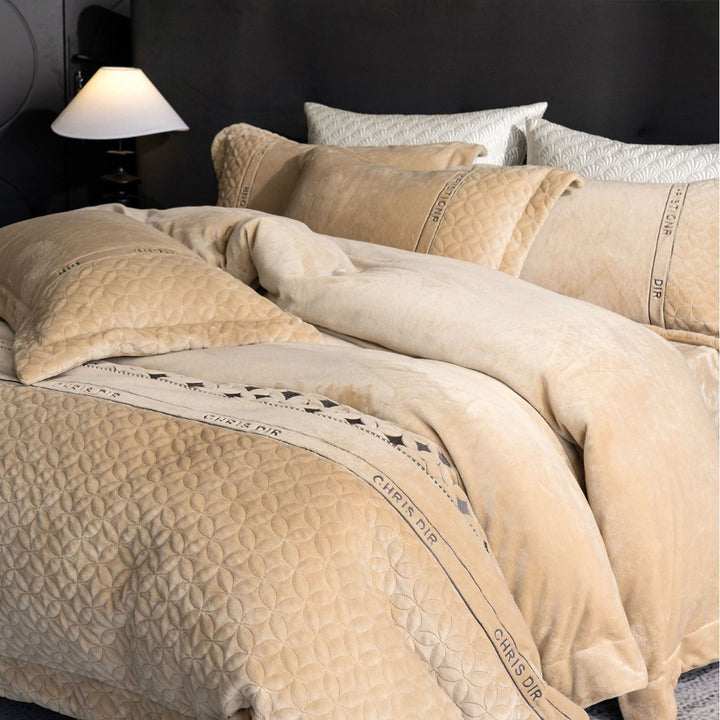 Quilted bedding set with geometric quilting and decorative ribbon