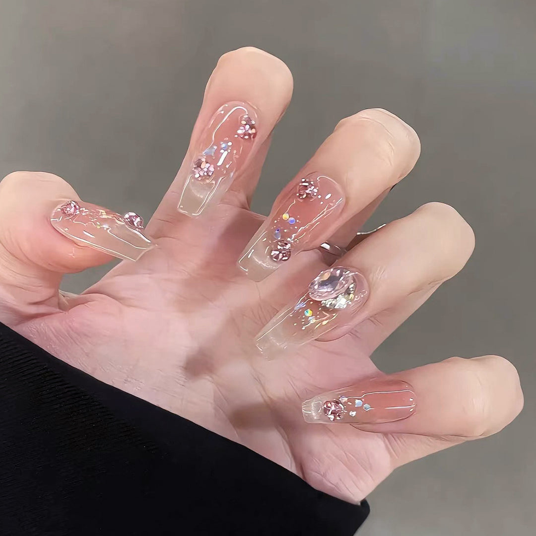 Artificial nail extensions with artistic glitter accents Stornfield