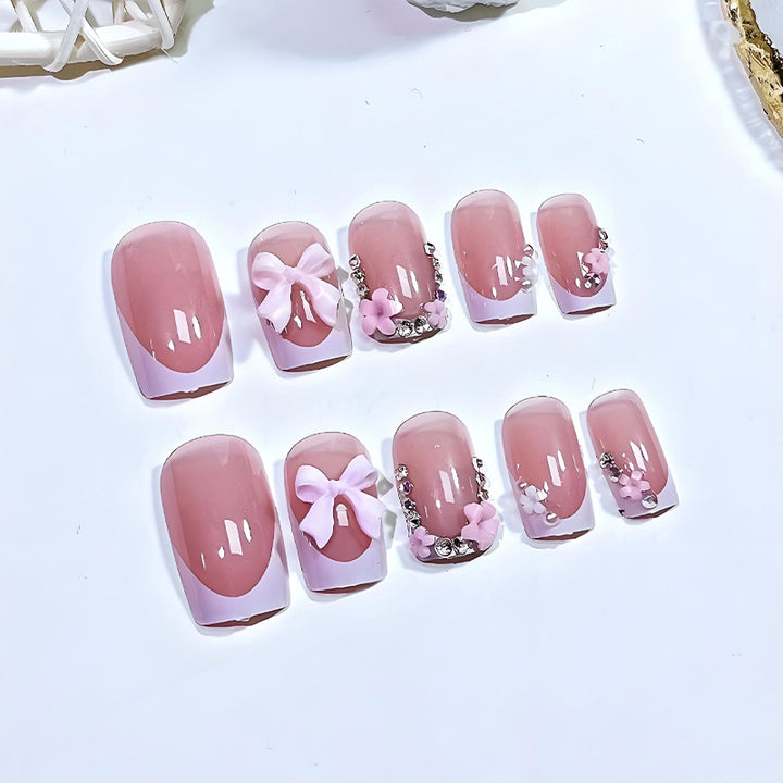 Artificial nail set with playful bows and elegant floral decorations Stornfield