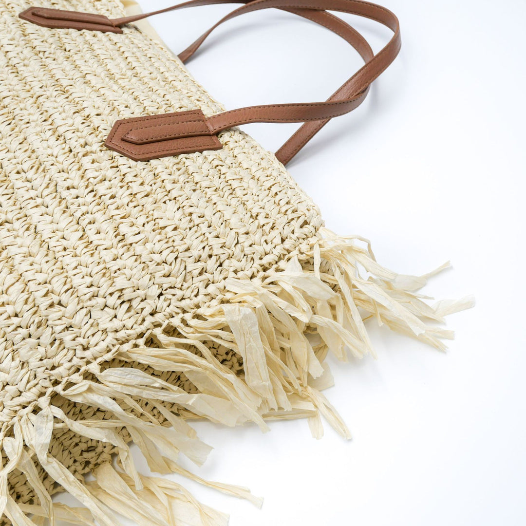 Beach bag made of handwoven straw with fringes Stornfield