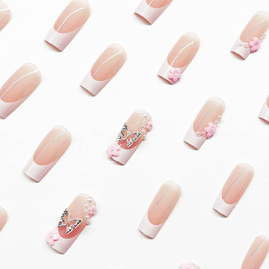 Artificial nail set with playful 3D flowers and glitter accents Stornfield