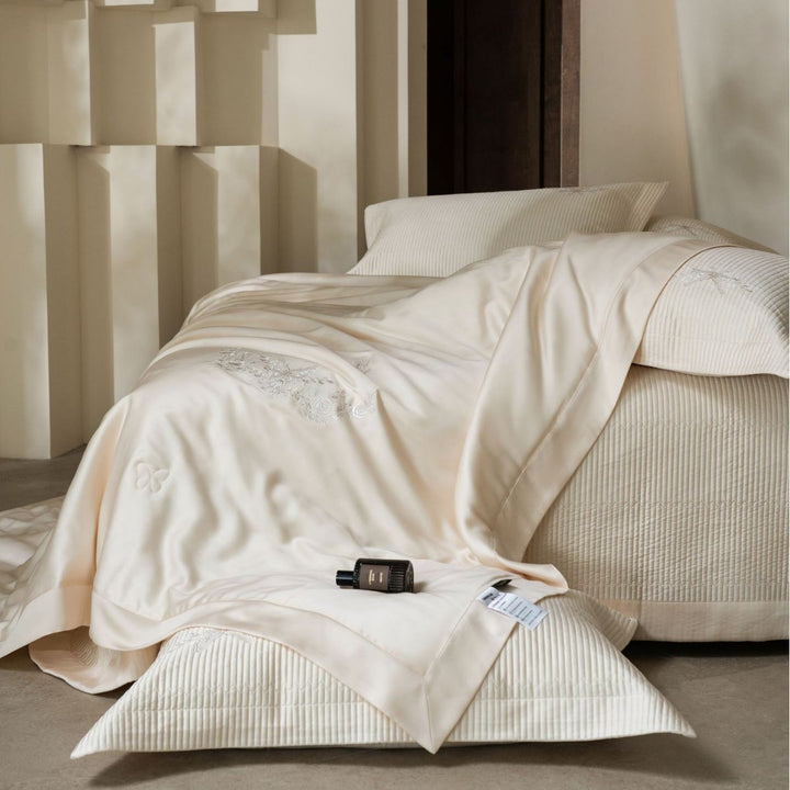 Luxurious cotton satin bedding set with quilted bedspread and floral embroidery