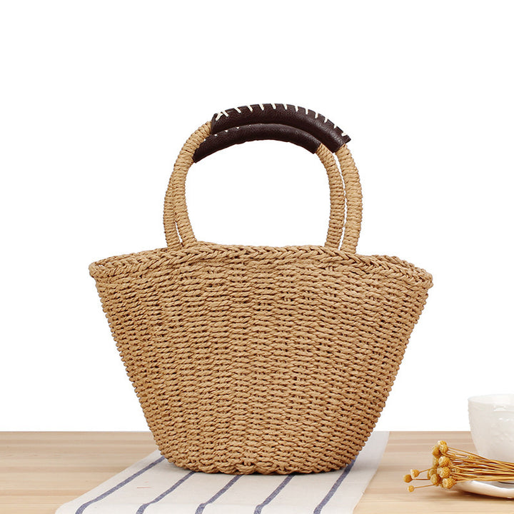 Basket bag made of woven natural material with leather handles Stornfield