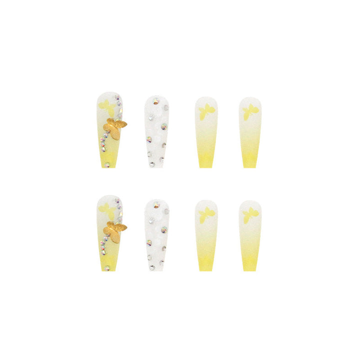 Artificial nail extensions with floral accents and rhinestones Stornfield