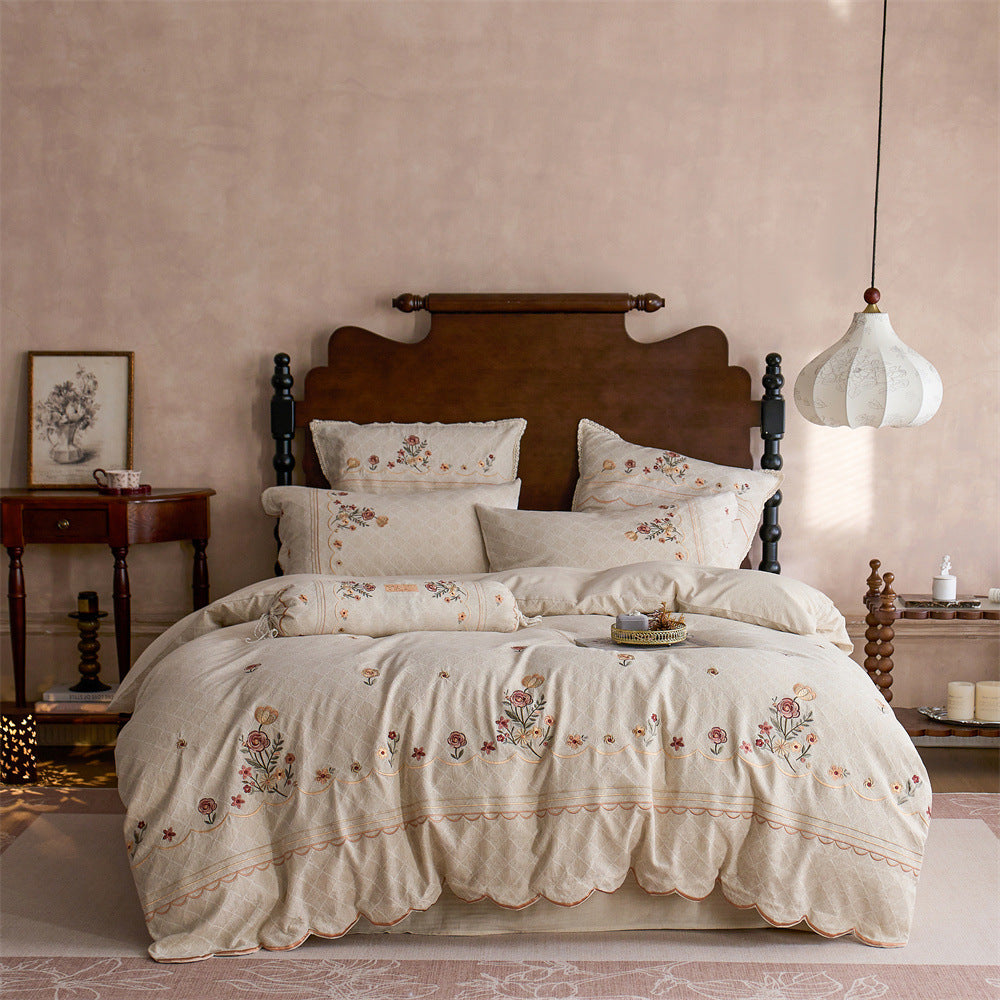 Luxurious embroidered cotton bedding set with ruffle and decorative pillow