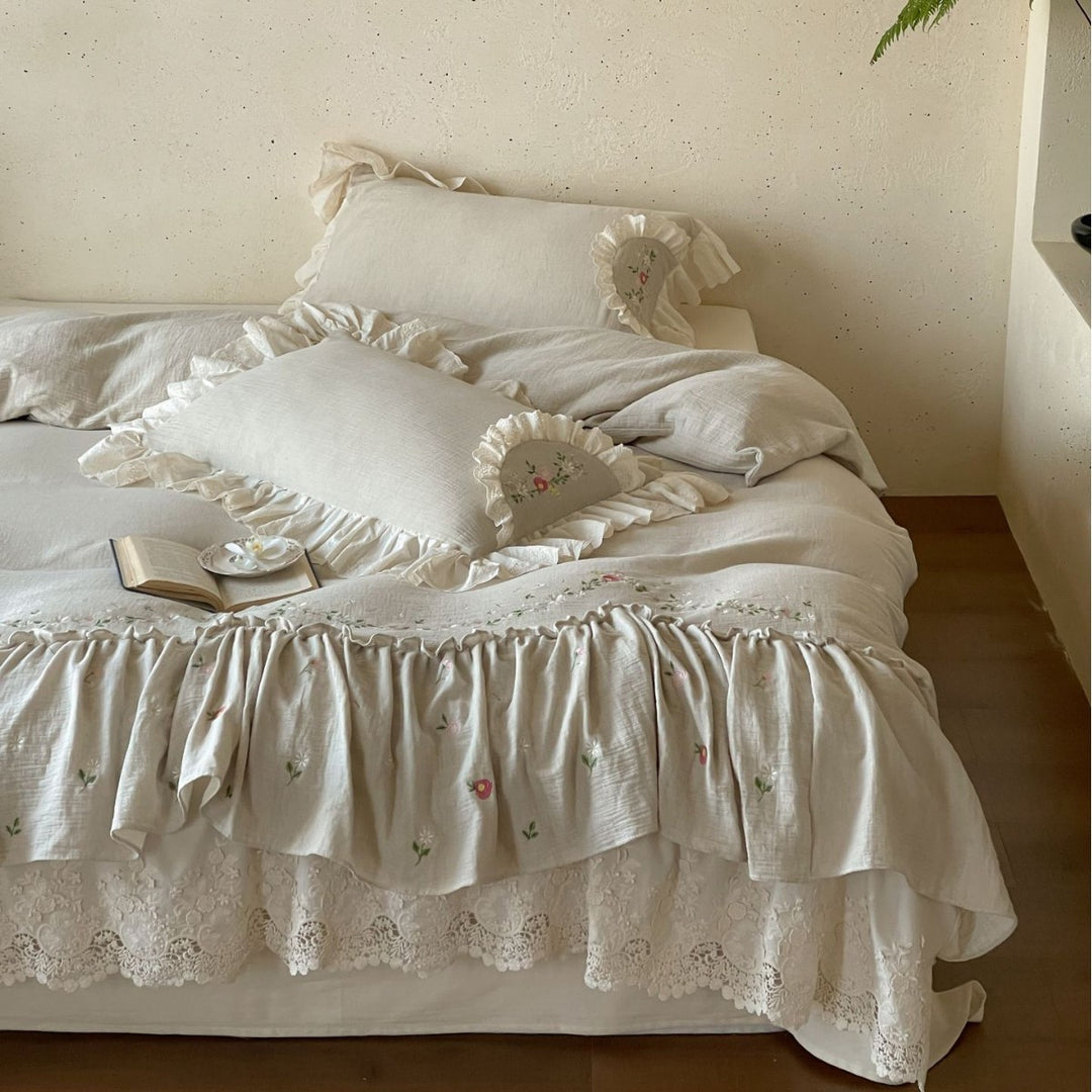 Linen bedspread in country house style with embroidered ruffle and lace edge