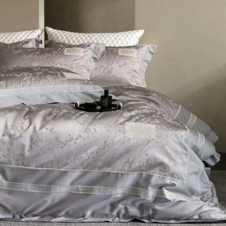 Luxurious satin bedding with jacquard floral pattern and lace trim