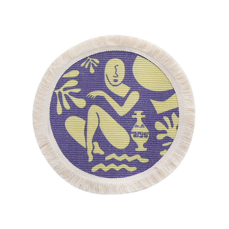 Round woven placemat with fringes and abstract figure motif Stornfield