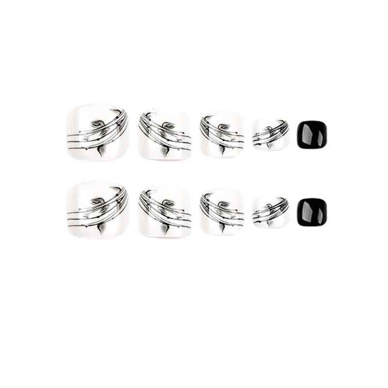 Artful toenail art in elegant black and white design Stornfield