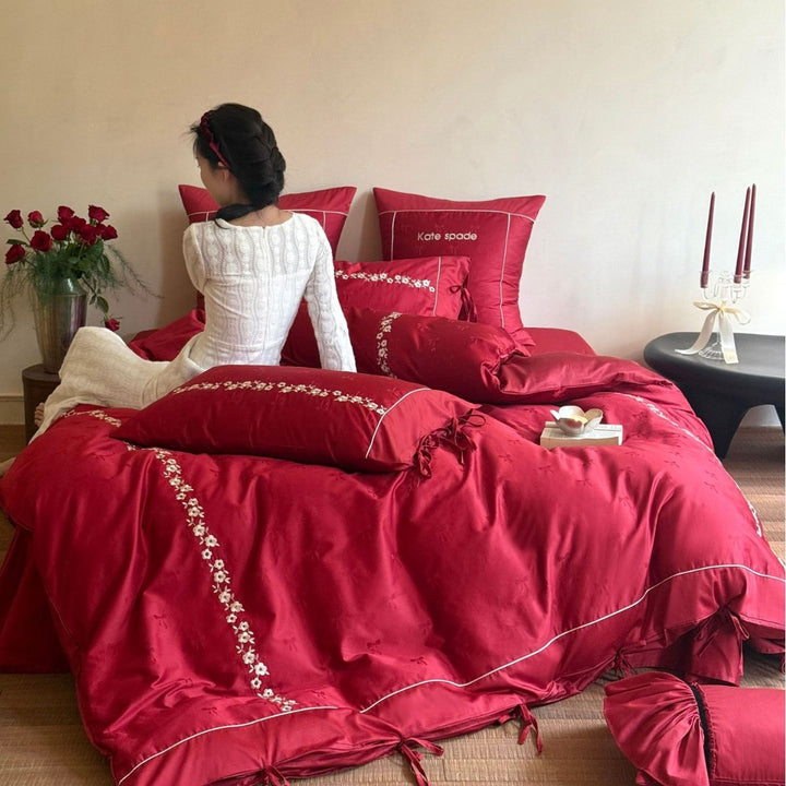 Bedding set made of cotton satin with floral border embroidery, decorative bows and pillow ensemble
