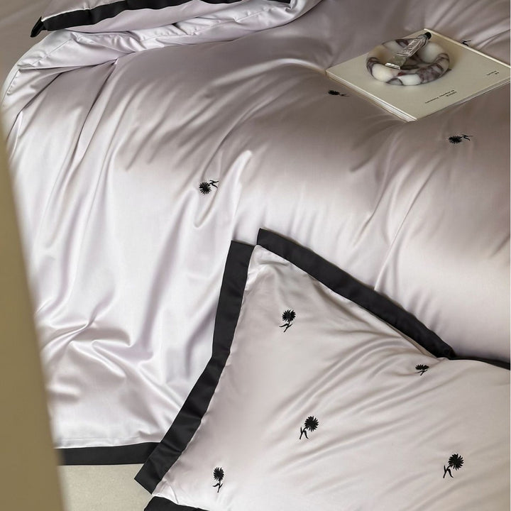 Elegant satin bed set with fine cherry embroidery and contrasting piping