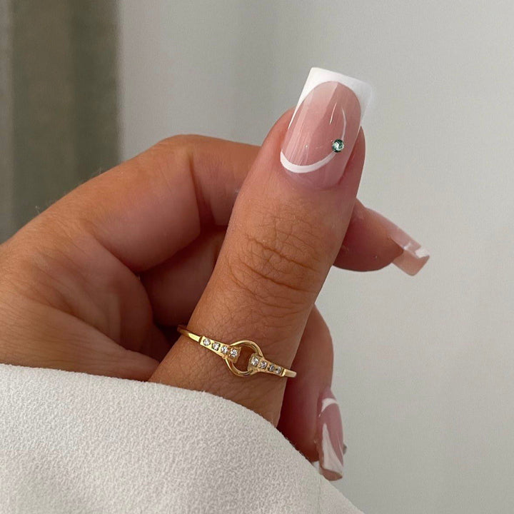 Artificial nail set with elegant French tips and glamorous rhinestone decorations Stornfield