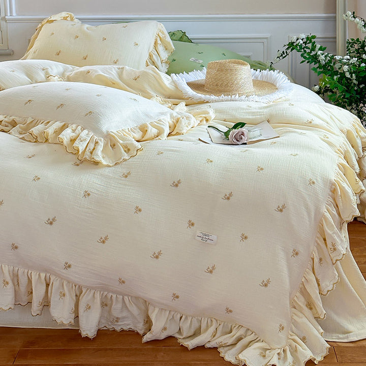 Vintage-inspired bedding set with ruffles and delicate floral embroidery