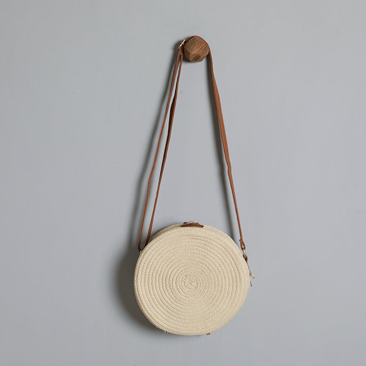 Round shoulder bag made of natural material with stylish accents Stornfield