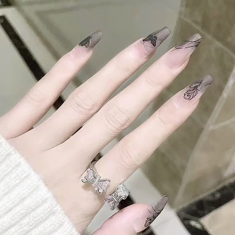 Artificial nail set with elegant flower design and delicate butterfly motifs Stornfield