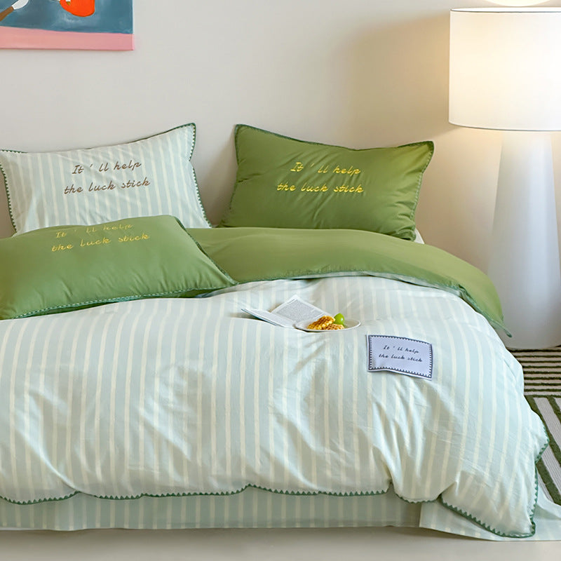 Striped cotton bedding set with subtle slogan appliqués and decorative piping