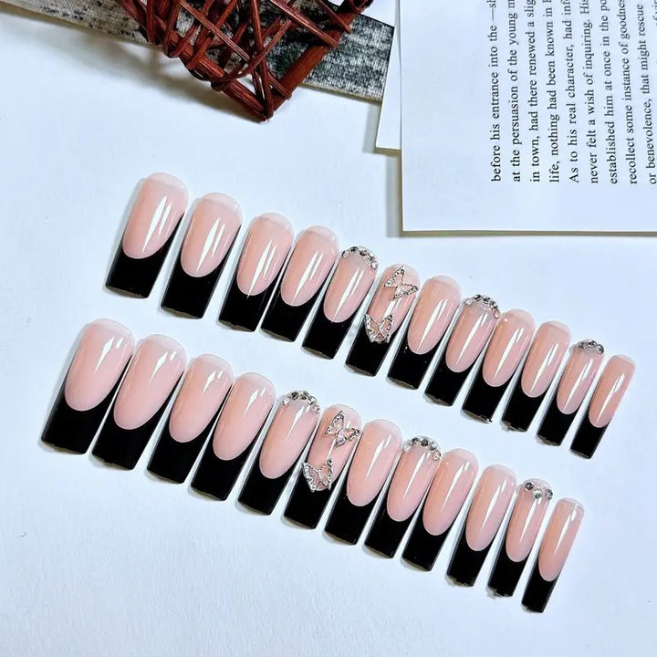 Trendy artificial nails with delicate rhinestone and butterfly accents Stornfield