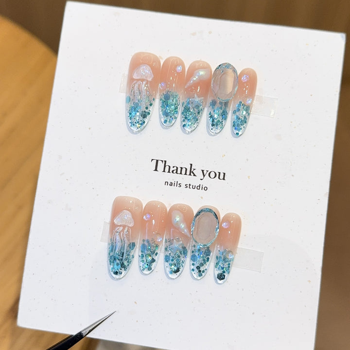 Creative artificial nails with maritime designs and sparkling accents Stornfield