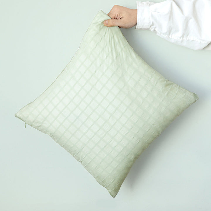 Square decorative cushion with delicate mother-of-pearl look and fine micro tuft structure
