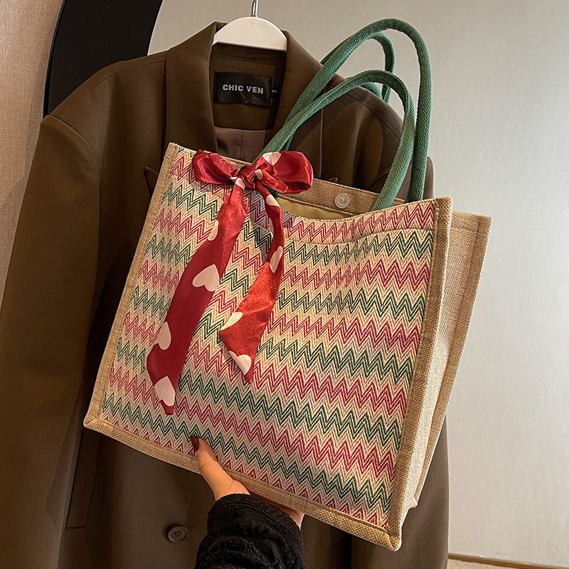 Textured Handbag with Decorative Bow