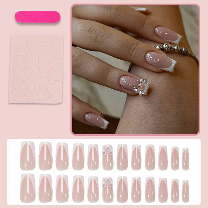 Artificial nail set with luxurious French tips and elegant jewelry embellishments Stornfield