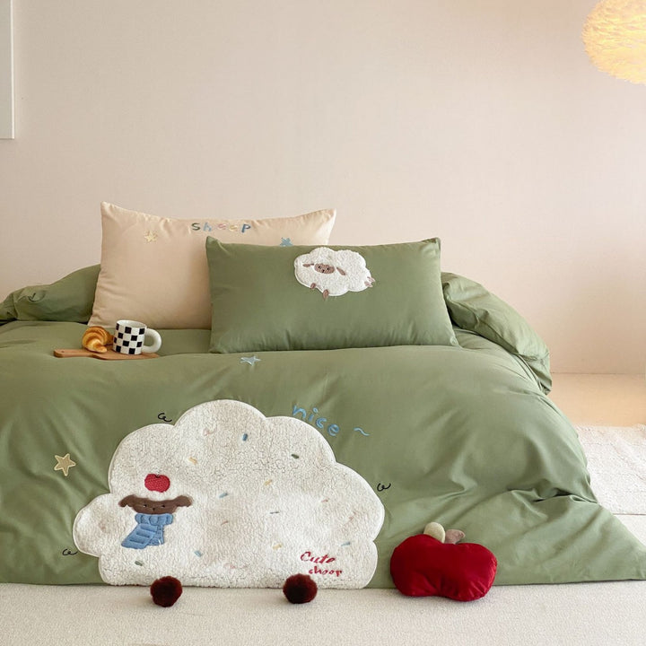 Children's bedding set with appliquéd duck figure, embroidered details, and extra soft microfiber cover