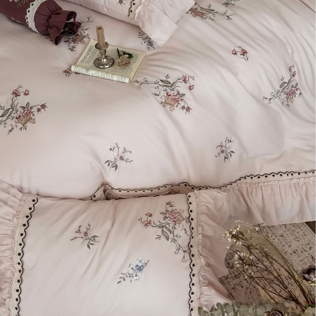 Romantic bedding set with ruffle, floral embroidery and decorative roll