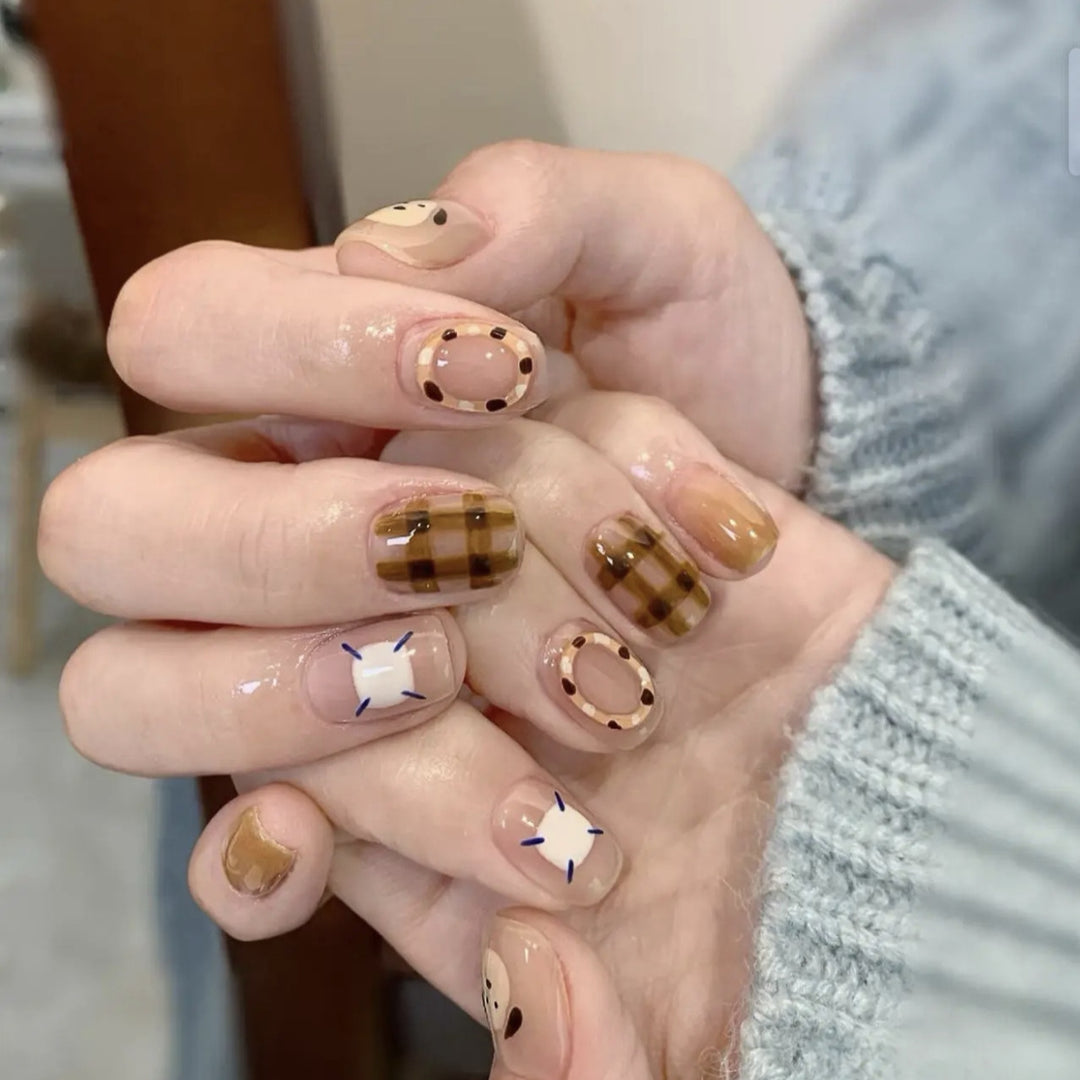 Playful artificial nails with cute animal and pattern accents Stornfield