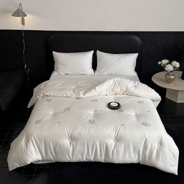 Quilted all-season duvet with floral embroidery and button detailing