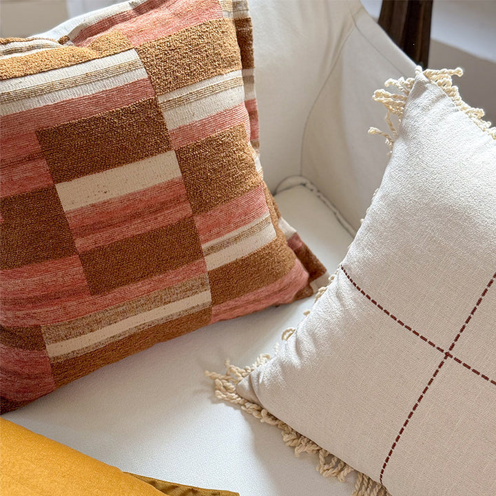 Decorative cushion made of linen look with hand-tied fringes and cross-stitch detail