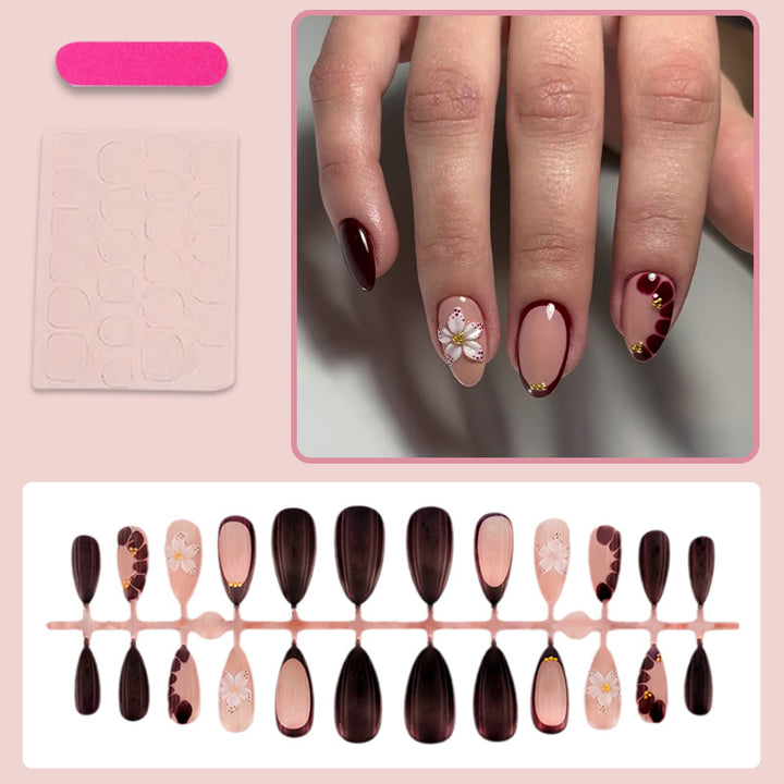 Acrylic nail set with elegant floral patterns and glamour accents Stornfield
