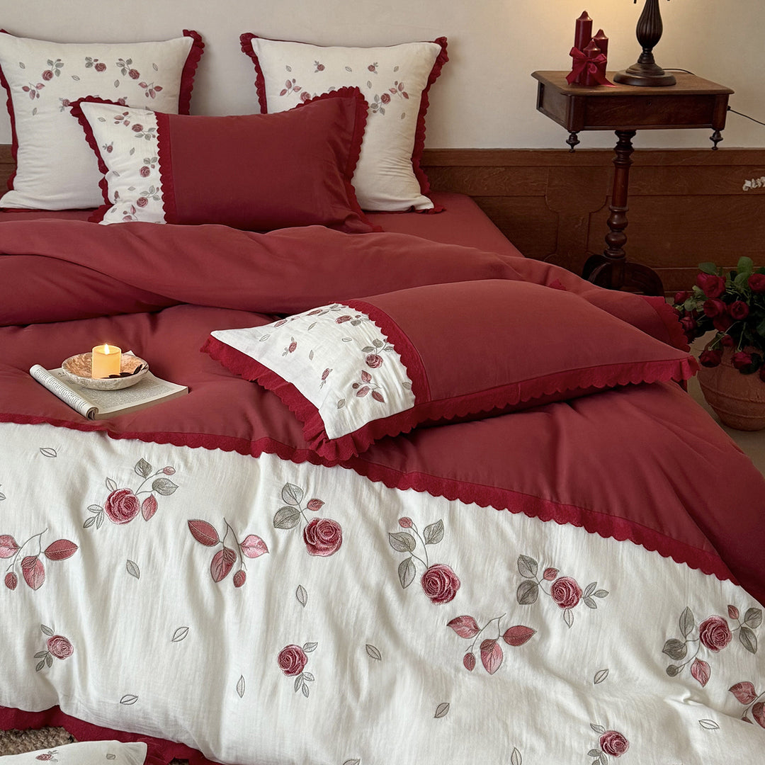 Bedding set with embroidered rose motif, ruffle and reversible feature