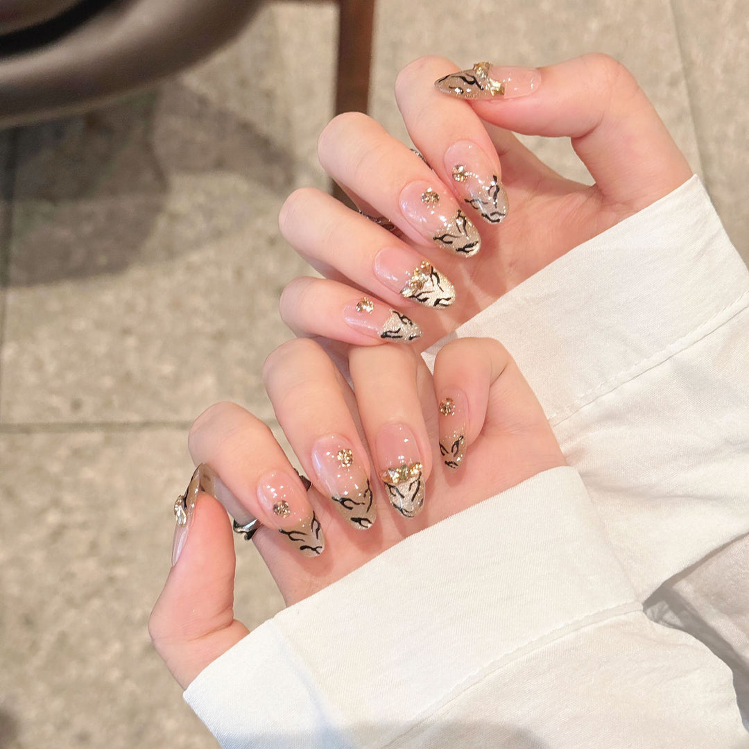 Artistic Press-On Nail Art Set with Luxurious Gold and Black Motifs