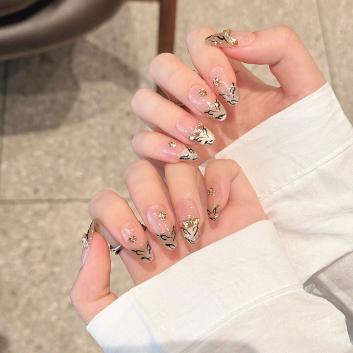 Artistic Press-On Nail Art Set with Luxurious Gold and Black Motifs
