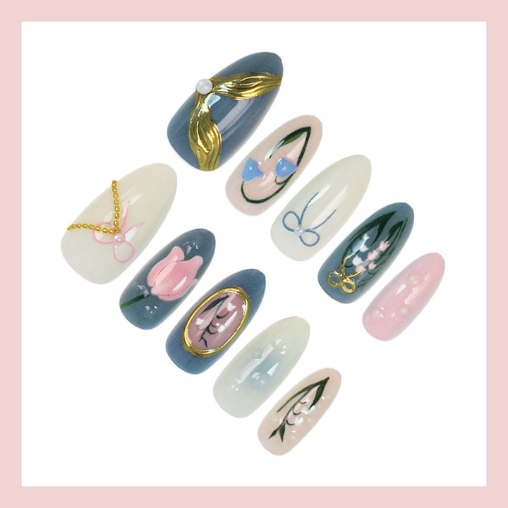 Acrylic nail set with floral design and elegant gold embellishments Stornfield