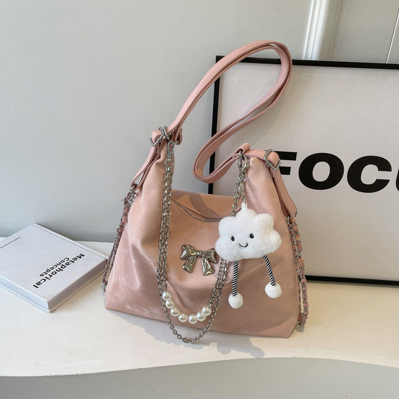 Fashionable handbag with unique pendant and chain accents Stornfield