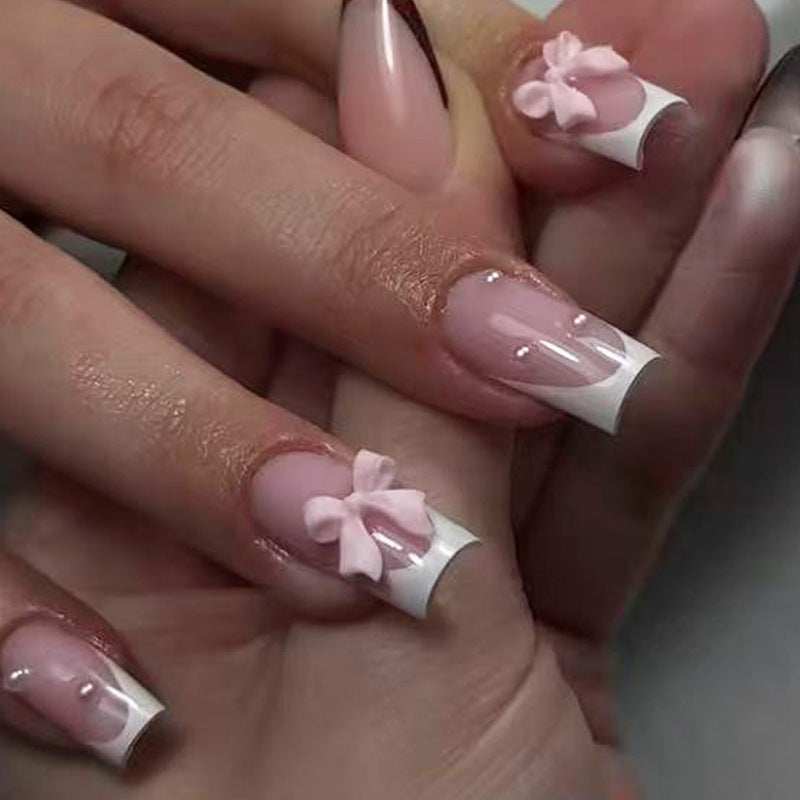 Nail art set with playful ribbon designs and elegant accents Stornfield