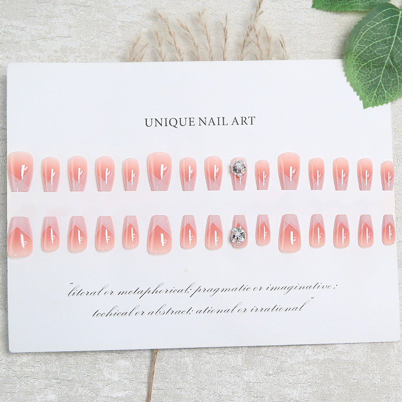 Artificial nail set with filigree tip designs and glamorous rhinestone accents Stornfield