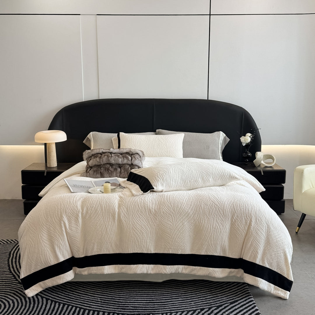 Quilted bedding set made of cotton blend with raised leaf texture and contrasting border