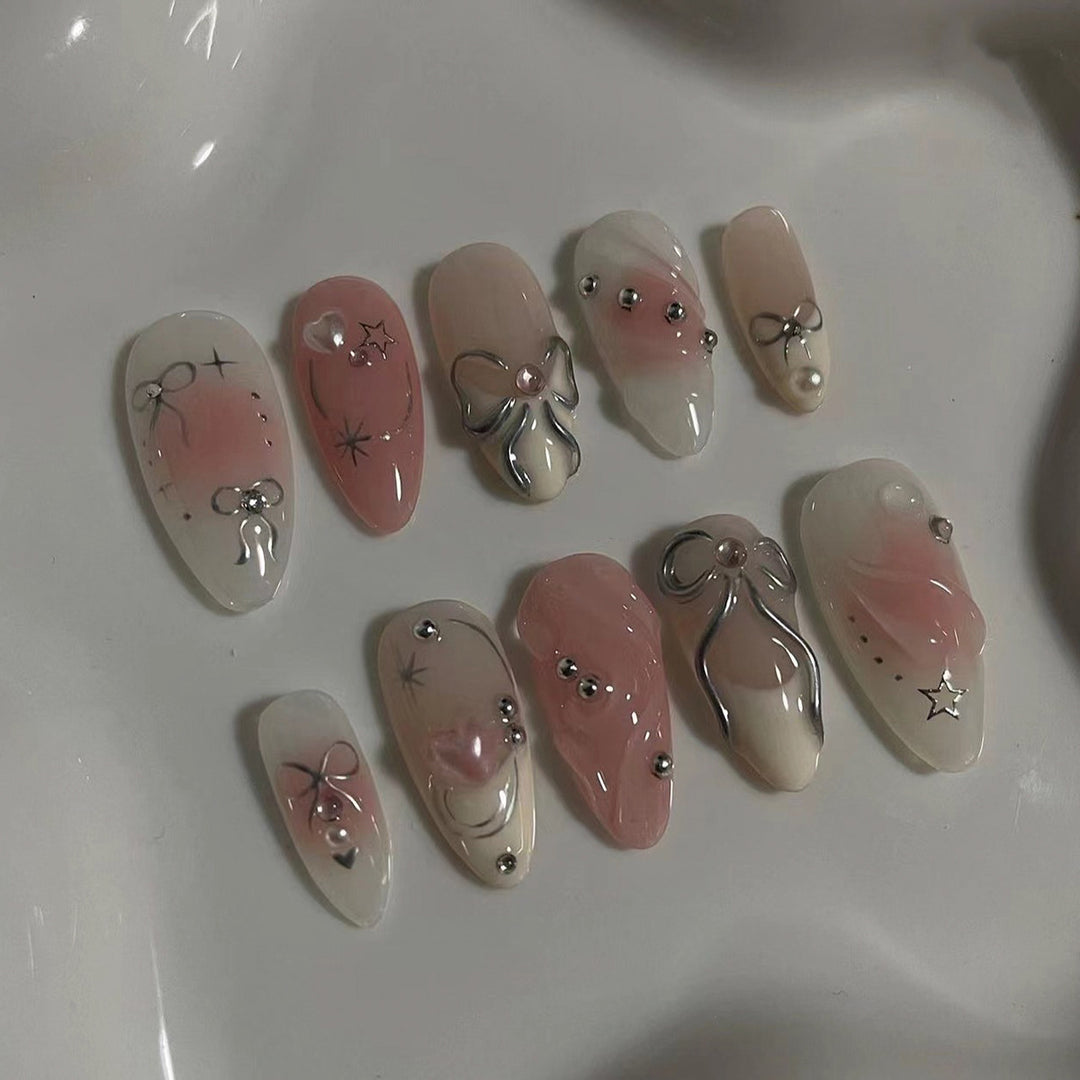 Artistic Nail Tips with Glitter and Bow Motifs Stornfield