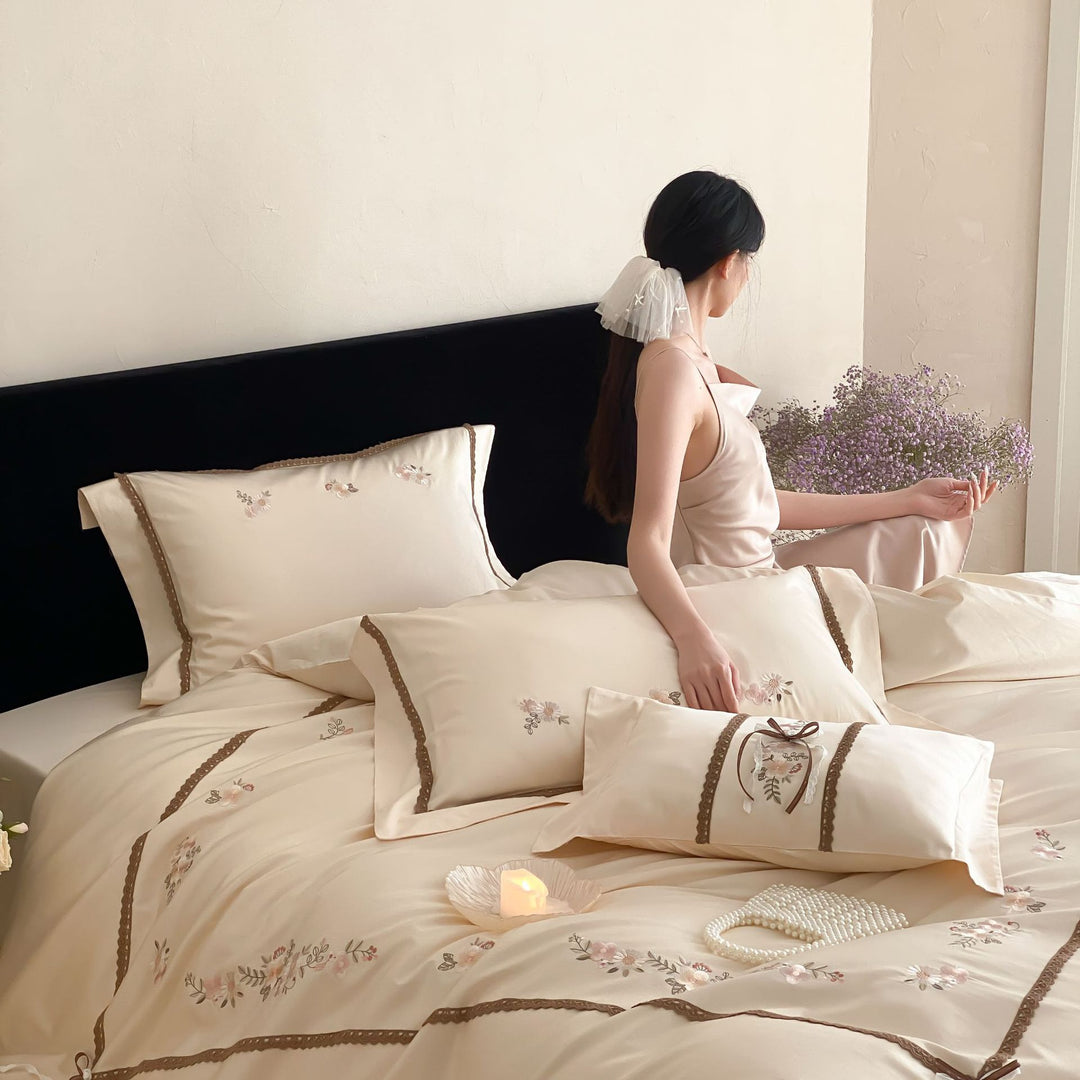 Embroidered bed linen set made of cotton satin with lace trim and floral appliqués