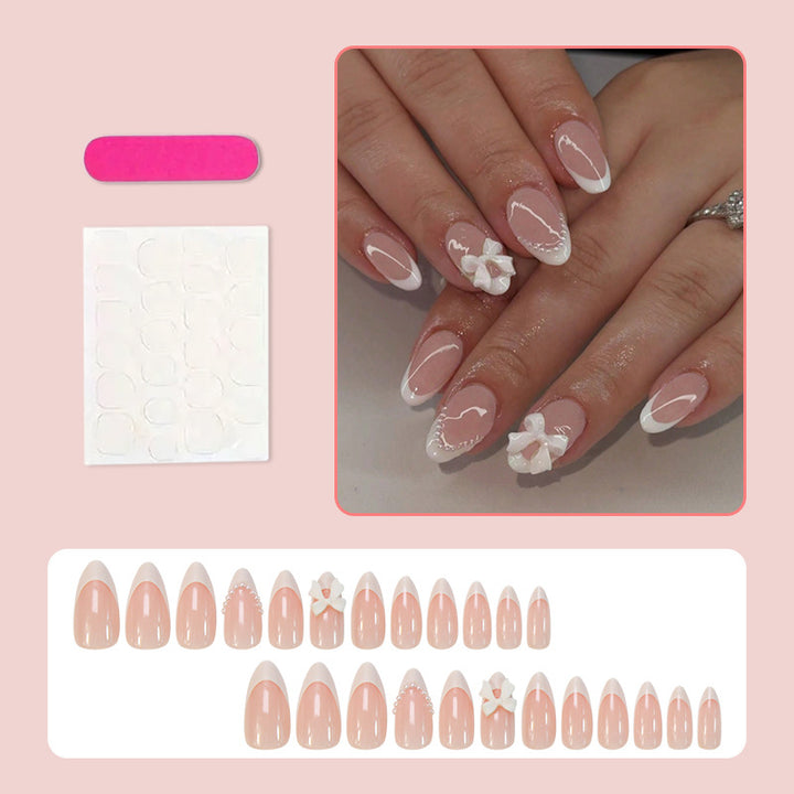 Acrylic nail set with elegant floral embellishments and trendy French tip Stornfield