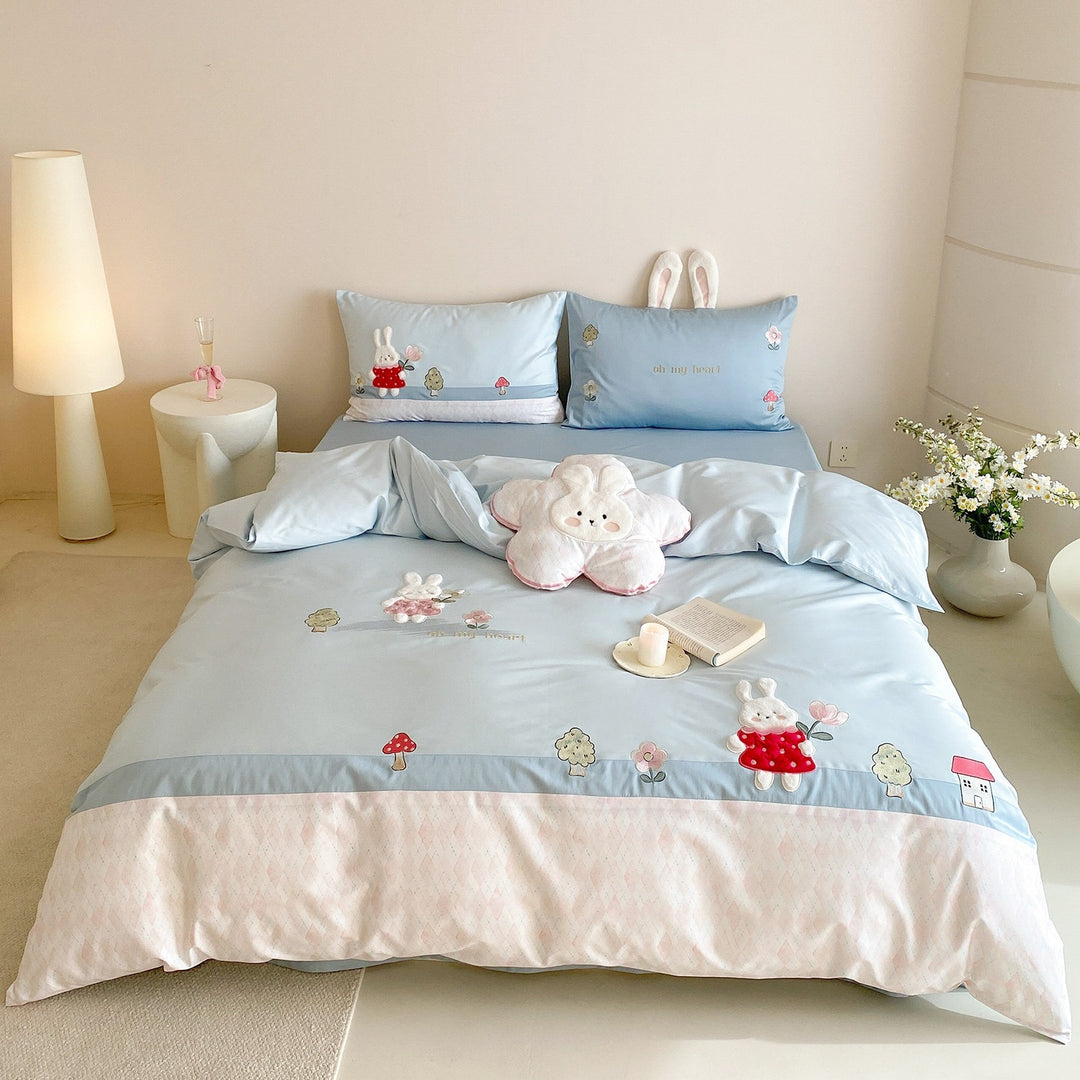 Playful cotton satin bed linen set with embroidered bunny appliqués and plush pillow